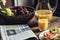 Still life of newspaper, breakfast with cakes, juice and Ð’Â fruits on kitchen table in front